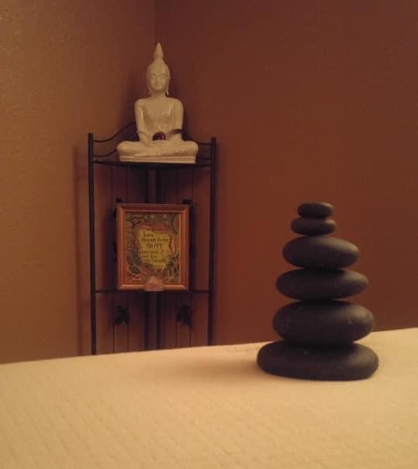 Massage table with stones on it at Serendipity Wellness Spa